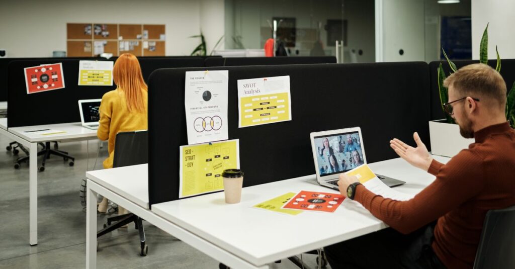 Colleagues working and collaborating virtually at a stylish modern office workspace.